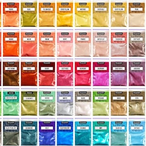May include: A collection of mica powder in small, clear plastic bags. Each bag is labeled with a color name, such as "Orange Golden," "English Red," and "Lime Green." The powders are various colors, including gold, red, pink, and green.