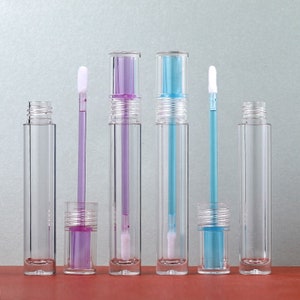 May include: Five clear plastic tubes with applicators. Two tubes have a purple liquid inside, two have a blue liquid inside, and one is empty.