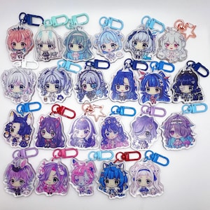 May include: A collection of twenty-three clear acrylic keychains featuring colourful anime-style chibi character illustrations. Each keychain is attached to a plastic or metal clasp in various colours, including blue, red, purple, and pink.