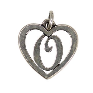 May include: A silver-toned pendant in the shape of a heart with a stylized letter "O" in the center. The pendant has a loop at the top for a chain. The metal has a slightly aged appearance.