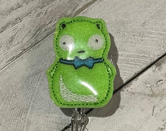 Louise’s green toy with bow tie retractable badge reel