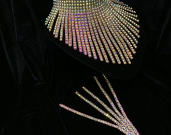 May include: An iridescent crystal choker necklace with a fringe design. The necklace is on a black velvet background.