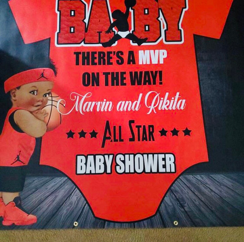 May include: A red and black baby onesie with a basketball theme. The onesie has the word "BABY" in large white letters at the top. The text "THERE'S A MVP ON THE WAY! Marvin and Rikita *ALL STAR* BABY SHOWER" is printed in white on the onesie. A cartoon basketball player is printed on the onesie.