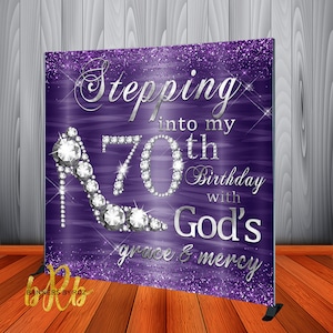 May include: Purple sparkly background with a silver glitter 70 and a silver high heel shoe with diamonds. The text reads "Stepping into my 70th Birthday with God's grace & mercy".
