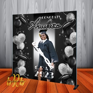May include: Black and silver graduation backdrop with a photo cutout, balloons, and the text "Congrats Andrea Grad 2023".