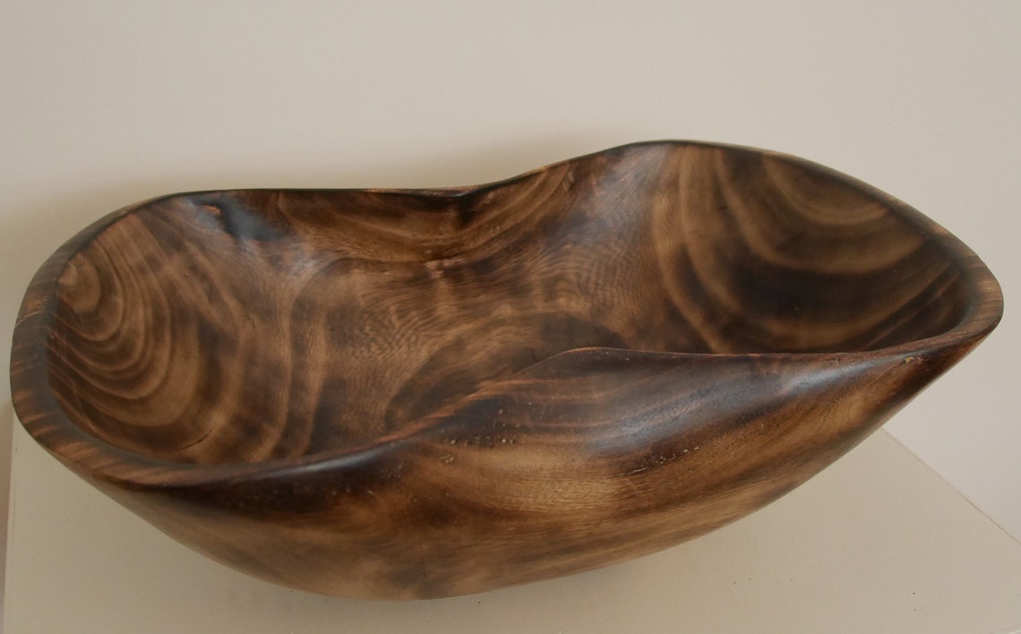 Rustic artisan wooden bowl with inward curved edges from Etsy