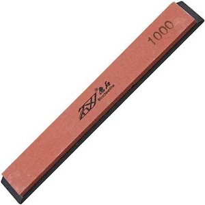 May include: A rectangular sharpening stone with a reddish-brown surface and black edges. The number "1000" is printed in the upper right corner. The brand name "Bladeelite" is printed on the stone.