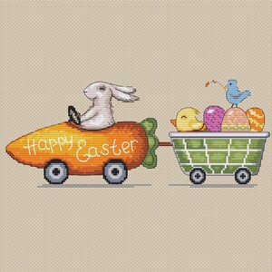 May include: A white bunny drives a carrot-shaped car with the words "Happy Easter" written on it. The car is pulling a wagon filled with colorful Easter eggs and a yellow chick.