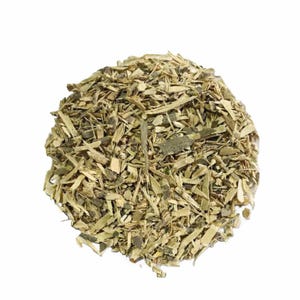 May include: A pile of dried, chopped bark pieces, primarily in shades of tan and olive green, against a white background. The texture appears rough and splintered, suggesting a natural, organic product. The pieces vary in size and shape.