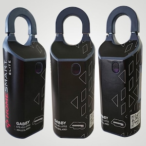 May include: Three black and gray HomeSmart Elite devices with a curved handle. The devices have a geometric pattern and a purple button. The text "GABBY" and contact information are visible on the devices.