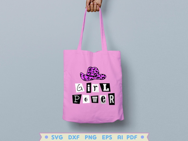 Pode incluir: Sacola de tecido rosa com um gr&aacute;fico em preto e branco que diz "girl power" e um chap&eacute;u de cowboy rosa e preto com estampa de leopardo.