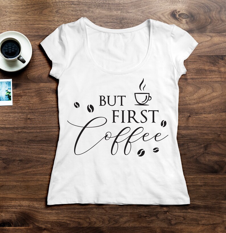 May include: White t-shirt with the text "But first, coffee" in black lettering. A coffee cup icon is above the word "first".
