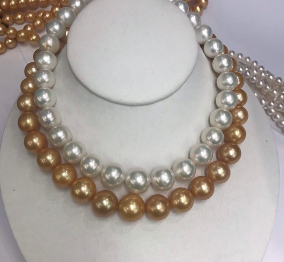 Gold and White Cultured Freshwater Pearls 11.5x15mm is the Gold Strand 11.5x15mm is the White 2 14k Gold Clasps 1 yellow Gold and White