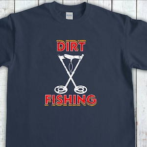 May include: A navy blue t-shirt with the text "DIRT FISHING" in red and yellow with a white silhouette of two metal detectors crossed over each other.