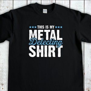 Könnte beinhalten: Schwarzes T-Shirt mit weißem Text, der "This is my Metal Detecting Shirt" lautet.