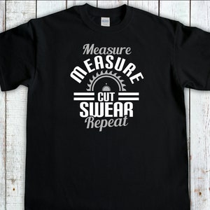May include: Black t-shirt with a white graphic design that says "Measure Cut Swear Repeat" with a saw blade icon.