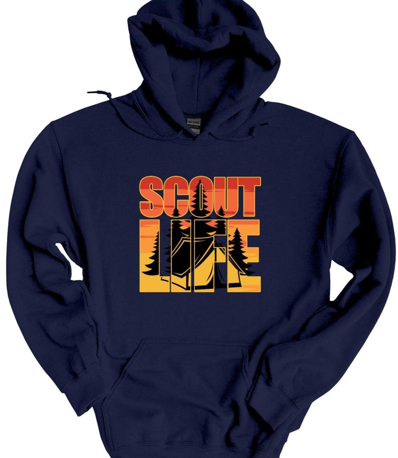 May include: Navy blue hooded sweatshirt with the words "SCOUT LIFE" in orange and yellow block letters. The design includes silhouettes of trees and a tent, evoking a camping theme. The sweatshirt has a front pocket and a drawstring hood.