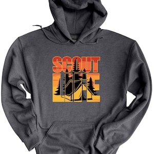 May include: Dark gray hooded sweatshirt with a front graphic. The graphic features the words "SCOUT LIFE" in orange and yellow, with a camping scene of a tent and trees.