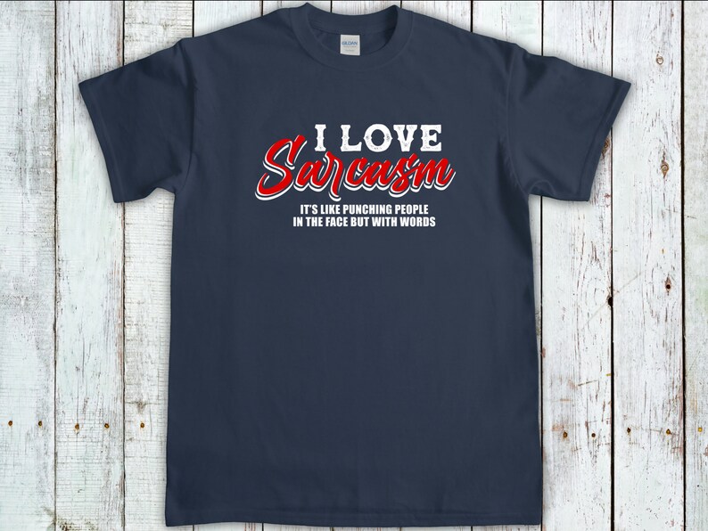 May include: A navy blue t-shirt with white text that reads "I love Sarcasm. It's like punching people in the face but with words." The text "Sarcasm" is in red.