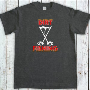 May include: Dark gray t-shirt with a white graphic of two crossed metal detectors and the text "DIRT FISHING" in red and yellow.