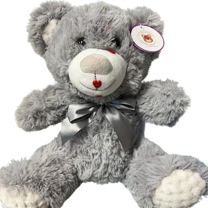 May include: A gray plush teddy bear with a silver bow, red heart accents on its face, and a white tag that says "Cuddlekins".