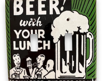 May include: A decorative light switch cover with a vintage beer-themed design. The black background features white text that reads "BEER! with YOUR LUNCH." A large beer mug and cartoon figures are also depicted. The border is green with vertical lines.