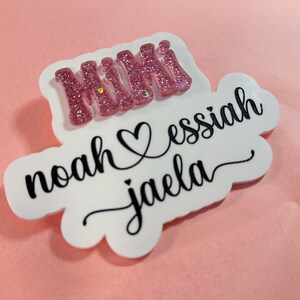 May include: White vinyl sticker with pink glitter lettering that says "Mimi" and black lettering that says "noah &hearts; essiah jaela"