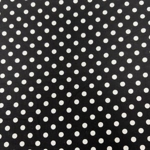 May include: Black fabric with a repeating pattern of white polka dots. The dots are evenly spaced and of a consistent size, creating a classic and versatile design. The fabric has a smooth texture and a matte finish.