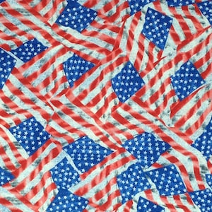 May include: A fabric print featuring a repeating pattern of American flags in red, white, and blue. The flags are arranged in a diagonal pattern and appear to be waving in the wind.