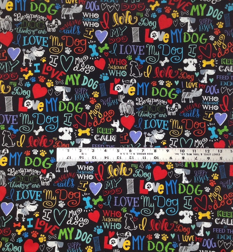 May include: Black fabric with a repeating pattern of colorful text that says "I love my dog" and other dog-related phrases. The fabric also features paw prints, hearts, and dog silhouettes.