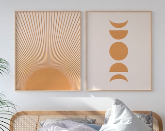 May include: A white bed with a light blue duvet and a wooden headboard with woven cane details. The bed is styled with pillows and a throw blanket. Two framed prints with abstract sun and moon designs hang on the wall above the bed. A wooden bench with woven cane details sits at the foot of the bed. A potted plant sits on a small wooden table next to the bed.