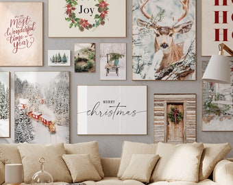 May include: A gallery wall featuring a variety of winter-themed prints, including a snowy forest scene, a deer in the snow, a cabin with a wreath on the door, and a sign that says "Merry Christmas".