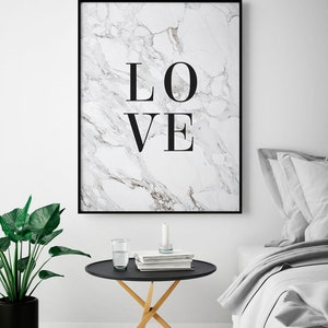 May include: A black framed print with a white marble background and the word "LOVE" in black text.