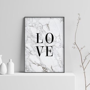 May include: A black framed print with a white marble background and the word "LOVE" in black text.