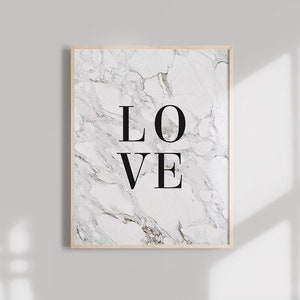 May include: A framed print with a white marble background and the word "LOVE" in black text.