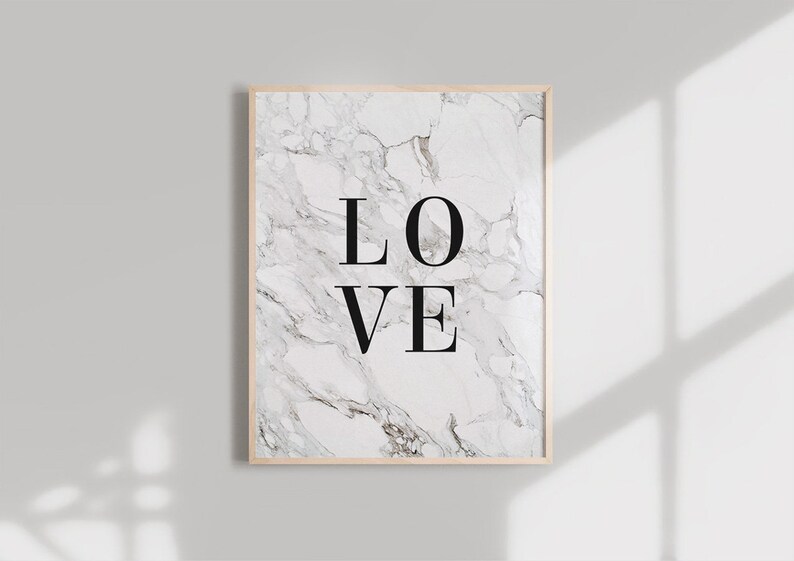 May include: A framed print with a white marble background and the word "LOVE" in black text.