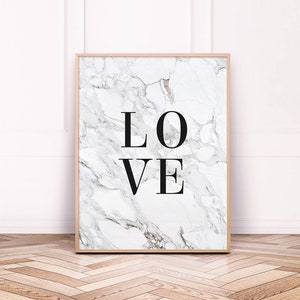 May include: A framed print with a white marble background and the word "LOVE" in black text.