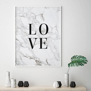 May include: A white framed print with a marble background and the word "LOVE" in black text.