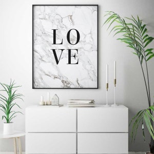 May include: A black framed print with a white marble background and the word "LOVE" in black text.