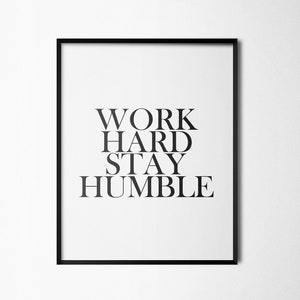 May include: Black and white framed print with the text "WORK HARD STAY HUMBLE" in a bold, sans-serif font.