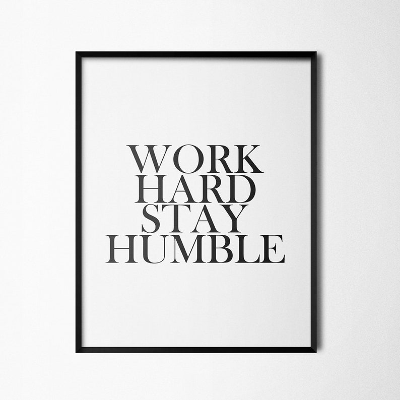 May include: Black and white framed print with the text "WORK HARD STAY HUMBLE" in a bold, sans-serif font.