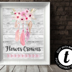 May include: A printable sign with a pink and white floral dreamcatcher design on a gray wood background. The text "Flower Crowns" is written in black below the dreamcatcher. The sign is decorated with pink and white arrows at the bottom.