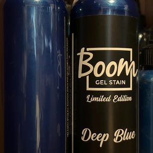 May include: Two dark blue bottles of Boom Gel Stain. One bottle is plain, the other has a black label with white text that reads "Boom GEL STAIN Limited Edition Deep Blue."