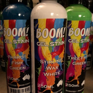 May include: Three 250ml bottles of gel stain with colorful labels. The labels feature the text "BOOM! Gel Stain" and different color options: Parrot Fish Green, Stirling Wax White, and Tree Frog Green.