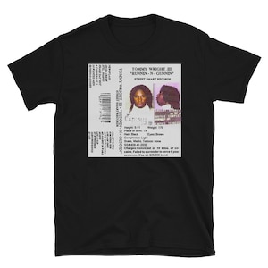 May include: A black and white cassette tape with a photo of a man on the front. The text on the tape reads "Tommy Wright III - "Runnin-N-Gunnin" Street Smart Records".