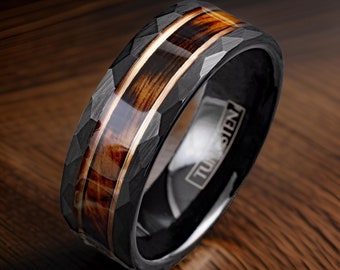 May include: A black tungsten ring with a hammered finish and a brown wood inlay. The ring has a rose gold accent and the word "TUNGSTEN" is engraved on the inside of the band.