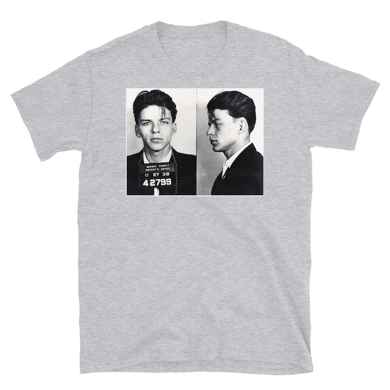 May include: Black and white mugshot of a man with short dark hair. The mugshot is from the Marion County Sheriff's Office and includes the man's booking number, 42799.
