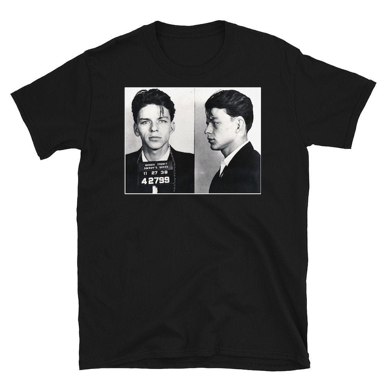 May include: Black and white mugshot style photo of two men. The men are facing forward and have their hair slicked back. The photo is printed on a black t-shirt.
