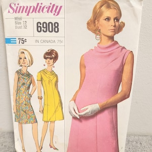 May include: A vintage Simplicity sewing pattern showing a pink dress design. The pattern includes illustrations of the dress and the text "Simplicity", "Size 12", and "6908". The price is marked as 75c.