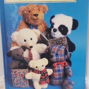 May include: A book titled "Easy to Make Teddy Bears" by Jill Plank. The book cover features a group of five teddy bears, including a panda bear, a brown bear, and three white bears. The bears are wearing colourful clothing and accessories.